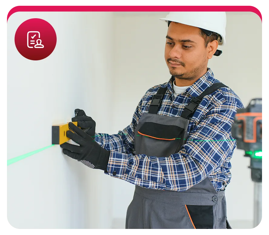 Ouvrier utilisant un niveau laser sur un mur